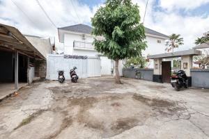 two motorcycles parked in front of a house at Lala Panzi Villa by Manara in Jimbaran
