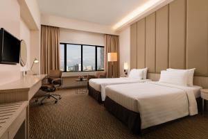 ジョージタウンにあるサンウェイ ホテル ジョージタウン ペナンのベッド2台とテレビがあるホテルの部屋