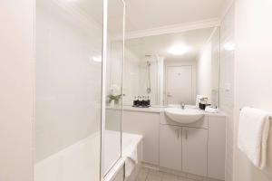 a white bathroom with a sink and a shower at MainStay Suites Williamstown in Williamstown +42 photos