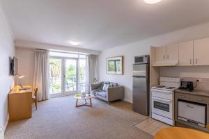 a kitchen and living room with a couch and a table at MainStay Suites Williamstown in Williamstown