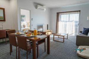 a living room with a dining table and a living room at MainStay Suites Whyalla in Whyalla