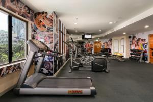 a gym with cardio equipment and posters on the walls at Sunway Hotel Georgetown Penang in George Town