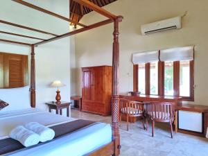 a bedroom with a bed and a desk and a table at Villa Diana Bali 14 Bedrooms in Seminyak +110 photos