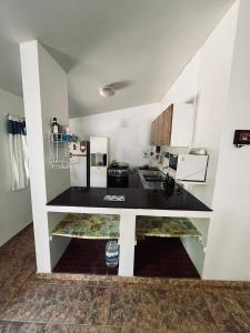 a large kitchen with white cabinets and a counter top at Davolio Hosting in Yerba Buena