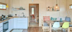 a kitchen with a table and chairs and a dining room at Self-Built Cabin With Views Over Leirvik in Leirvik
