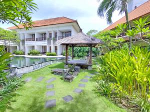 a garden with a gazebo and a pool at Villa Diana Bali 14 Bedrooms in Seminyak