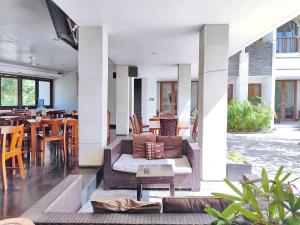 a living room with a couch and tables and chairs at Villa Diana Bali 14 Bedrooms in Seminyak