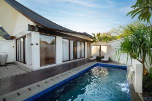 a swimming pool in the backyard of a villa at Amayi Resort Nusa Dua in Nusa Dua