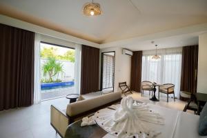 a living room with a couch and a table at Amayi Resort Nusa Dua in Nusa Dua