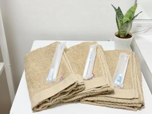 a pile of towels sitting on a table at MY HOUSE たいみんぐ kuwana 長島15分 名古屋20分 桑名駅徒歩3分 in Kuwana +39 photos