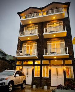 Ein Auto parkte vor einem Backsteingebäude in der Unterkunft King Castle Lake Front By Laksam in Nuwara Eliya + 9 Fotos