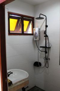 a bathroom with a sink and a window and a shower at Open Mind Center Villas in Ban Tha Pai