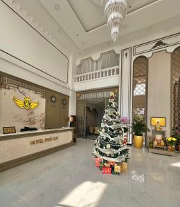 a christmas tree in the middle of a hotel lobby at Phu Gia Hotel 13-15 Hoàng Quốc Việt in Ho Chi Minh City