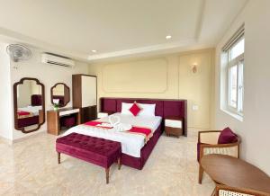 a bedroom with a large bed and a mirror at Phu Gia Hotel 13-15 Hoàng Quốc Việt in Ho Chi Minh City +46 photos