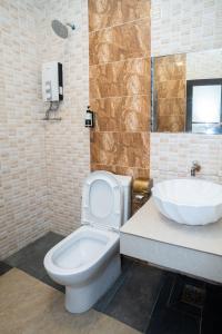 a bathroom with a white toilet and a sink at De Grand Boutique Hotel in Sepang +34 photos
