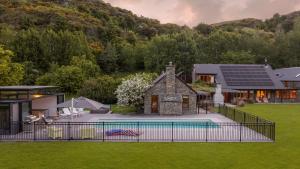 an image of a house with a swimming pool at Wharenui Holiday Home by MajorDomo in Arrowtown