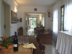 a living room with a table and two wine glasses at Huge Holiday Home in Marina di Castagneto Carducci near Sea in Donoratico
