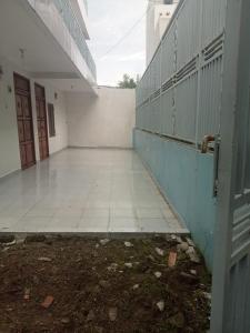 an empty hallway of a building with a gate at Penginapan amalia in Soreang +5 photos