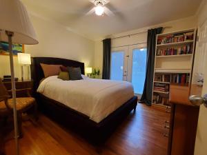 a bedroom with a bed and a book shelf at Hidden Gem In Plain Sight in Van Nuys Airport