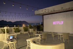 a patio with tables and chairs and a sign that reads notify at Royal Pavilion Hua Hin in Hua Hin