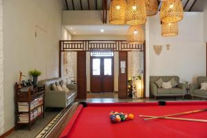 a living room with a pool table in the middle at Rumah Canda in Bandung