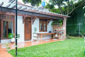 a patio with a wooden pergola at Rumah Canda in Bandung