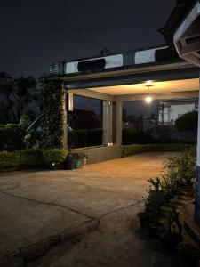 una casa con una entrada iluminada por la noche en Tuckedinn home, en Shillong