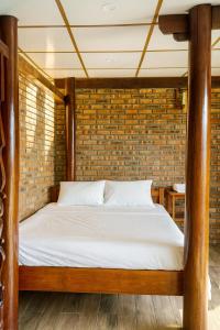 Ένα ή περισσότερα κρεβάτια σε δωμάτιο στο Củi Homestay Huế