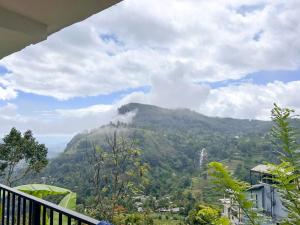 a view of a mountain from a balcony at Rokky Hill Cottage Ella in Ella