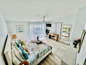 een slaapkamer met een bed en een spiegel bij Beachfront HouseSteps to Sand Sunset in Indian Rocks Beach