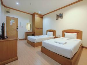 Postel nebo postele na pokoji v ubytování โรงแรมสบายโฮเทล โคราช + 16 fotografií