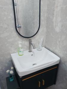 a bathroom with a sink and a mirror at GYANA House in Ubud