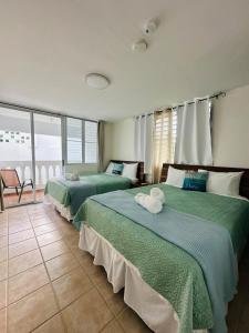 Postel nebo postele na pokoji v ubytování Verano Azul Beachfront Apartment in Isabela