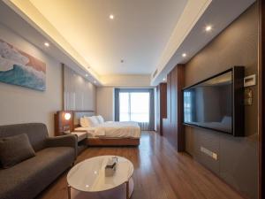 TV a/nebo společenská místnost v ubytování Dalian Zhongshan Square Seaview Meilun Hotel