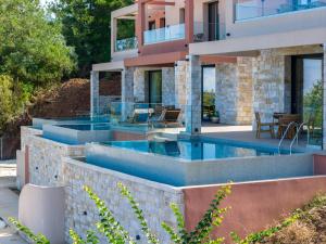 an exterior view of a house with a swimming pool at Green Sea Villas in Skala Potamias
