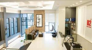 a lobby of a building with a staircase and a living room at B2 Hat Yai Rat Uthit Boutique & Budget Hotel in Sathani Hat Yai