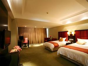 Ένα ή περισσότερα κρεβάτια σε δωμάτιο στο Longda Ruiji Business Hotel Harbin +258 φωτογραφίες