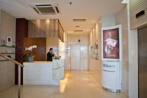 a man standing at a counter in a lobby at Sol Ipanema Hotel in Rio de Janeiro