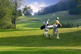 two men playing a game of golf in the grass at House Hommert Hoensbroek in Hoensbroek