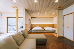 a living room with a couch and a bed at Tawarayama Onsen Ryokan Minawa in Minami Aso +111 photos