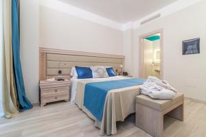 Postel nebo postele na pokoji v ubytování L'Ambasciata Hotel de Charme