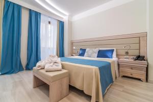 Postel nebo postele na pokoji v ubytování L'Ambasciata Hotel de Charme