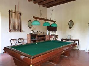 a room with a pool table and two chairs at Villa Maffei Rizzardi in Oppeano