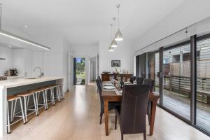 a kitchen and dining room with a table and chairs at White Sands Haven - Omaha Family Escape in Omaha