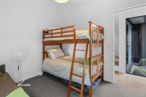 a room with two bunk beds and a bed at White Sands Haven - Omaha Family Escape in Omaha +4 photos