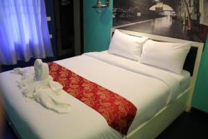 a bedroom with a bed with white towels on it at S30 in Bangkok