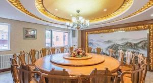 a room with a table and chairs and a large painting at James Joyce Coffetel·Chengde Mountain Resort Toudao Pailou in Chengde