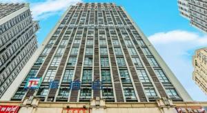 a tall building with a lot of windows at PAI Hotels·Jiangbei Airport Central Park in Chongqing