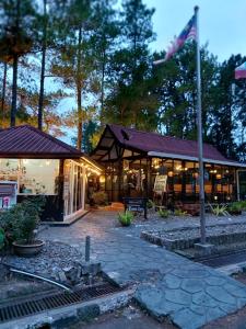 a building with a flag in front of it at Perkasa Hotel Mt Kinabalu in Kundasang