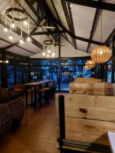 a restaurant with tables and chandeliers in a room at Perkasa Hotel Mt Kinabalu in Kundasang